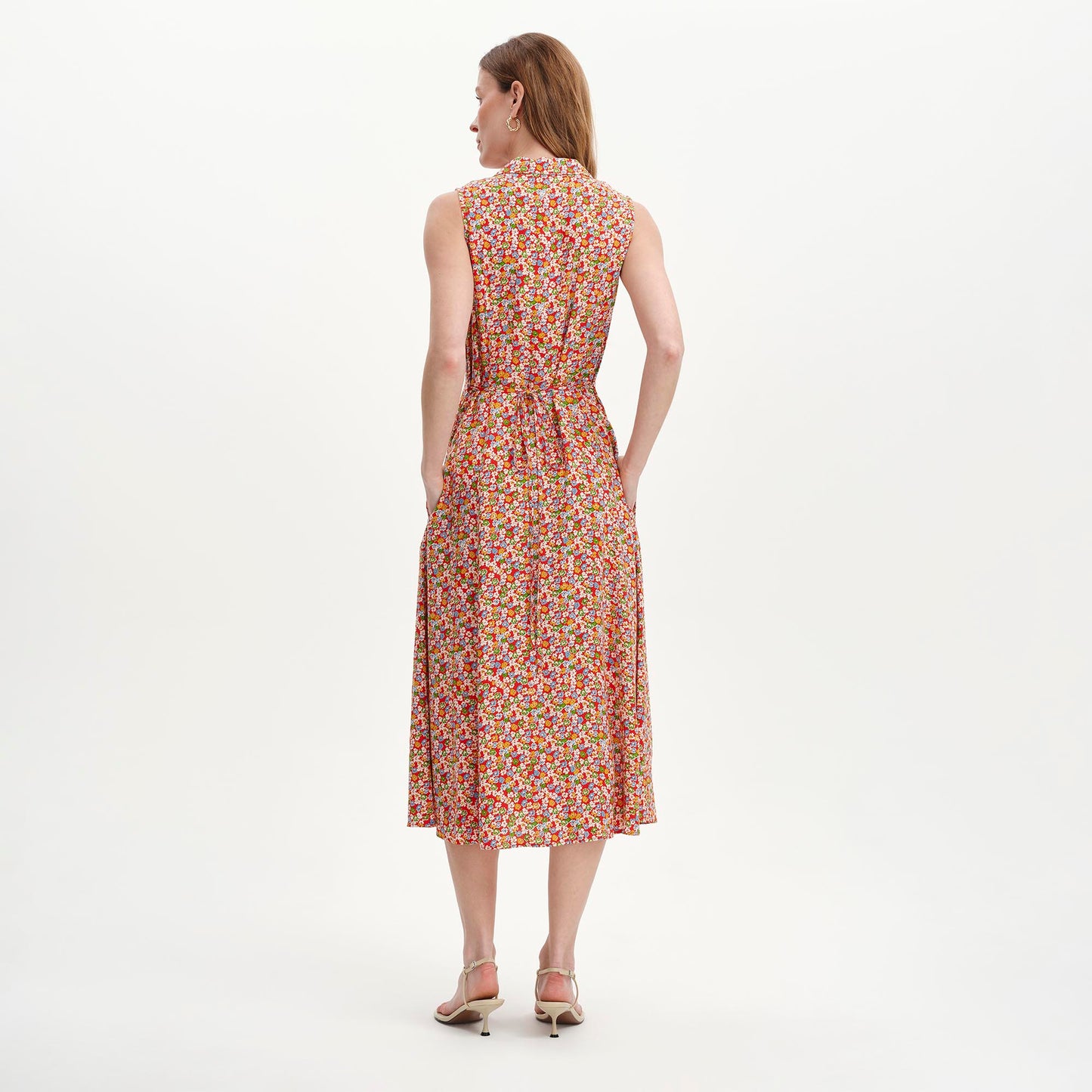 Woman wearing Beatrice Red Ditsy Sleeveless Midi Shirt Dress on a white background