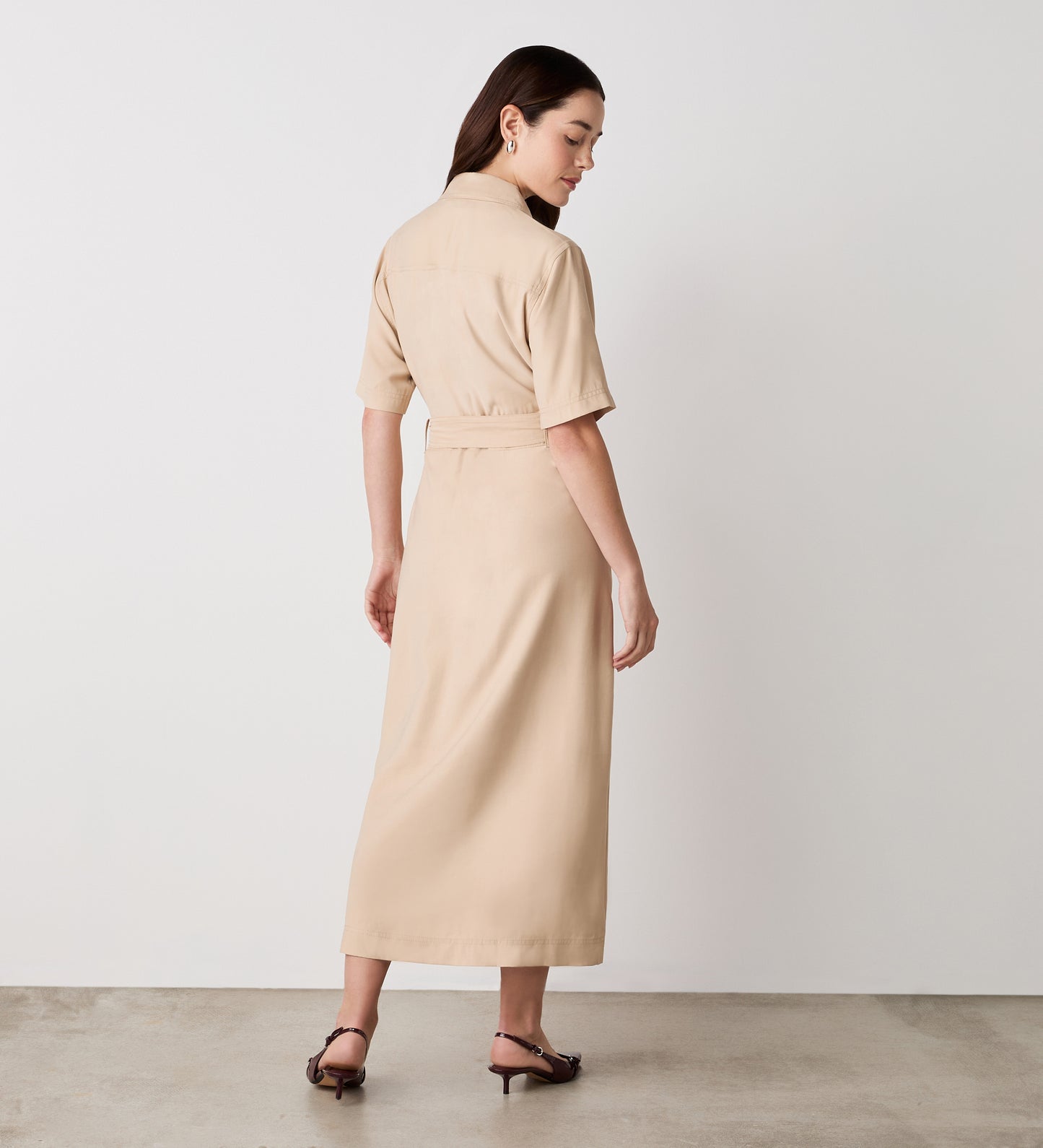 Full body back view of a model wearing the Cassidy Stone Midi Shirt Dress facing away from the camera.