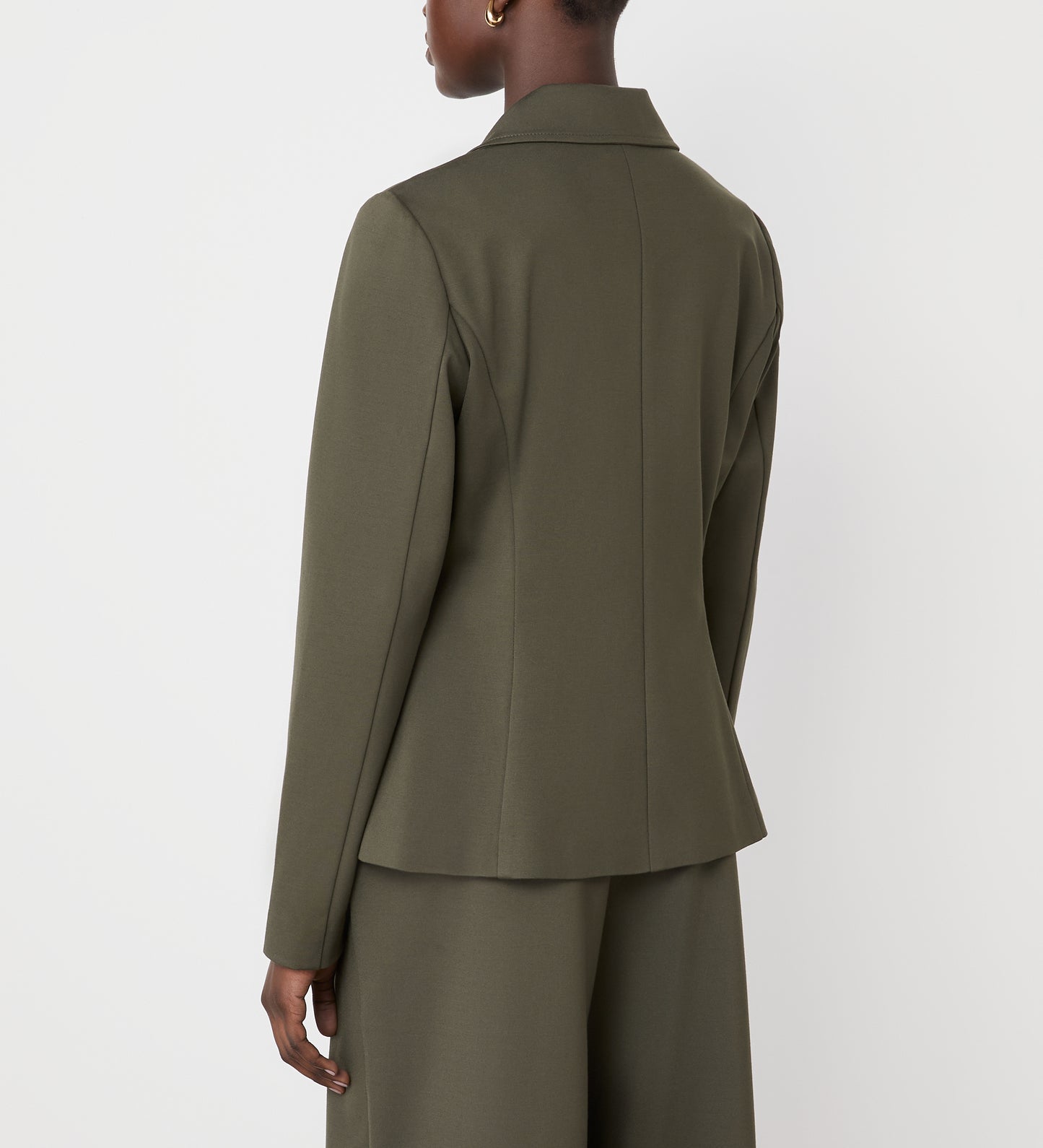 A person stands facing away, wearing the Jules Khaki Ponte Jersey Blazer with matching wide-leg trousers, set against a plain white background.