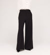 A person models the Addie Black Gaberdine Twill Wide Leg Trousers with a white blouse against a plain white background, their head not shown in the image.