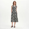 Woman wearing a Beatrice Black Ditsy Sleeveless Midi Shirt Dress white background