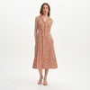 Woman wearing Beatrice Red Ditsy Sleeveless Midi Shirt Dress on a white background
