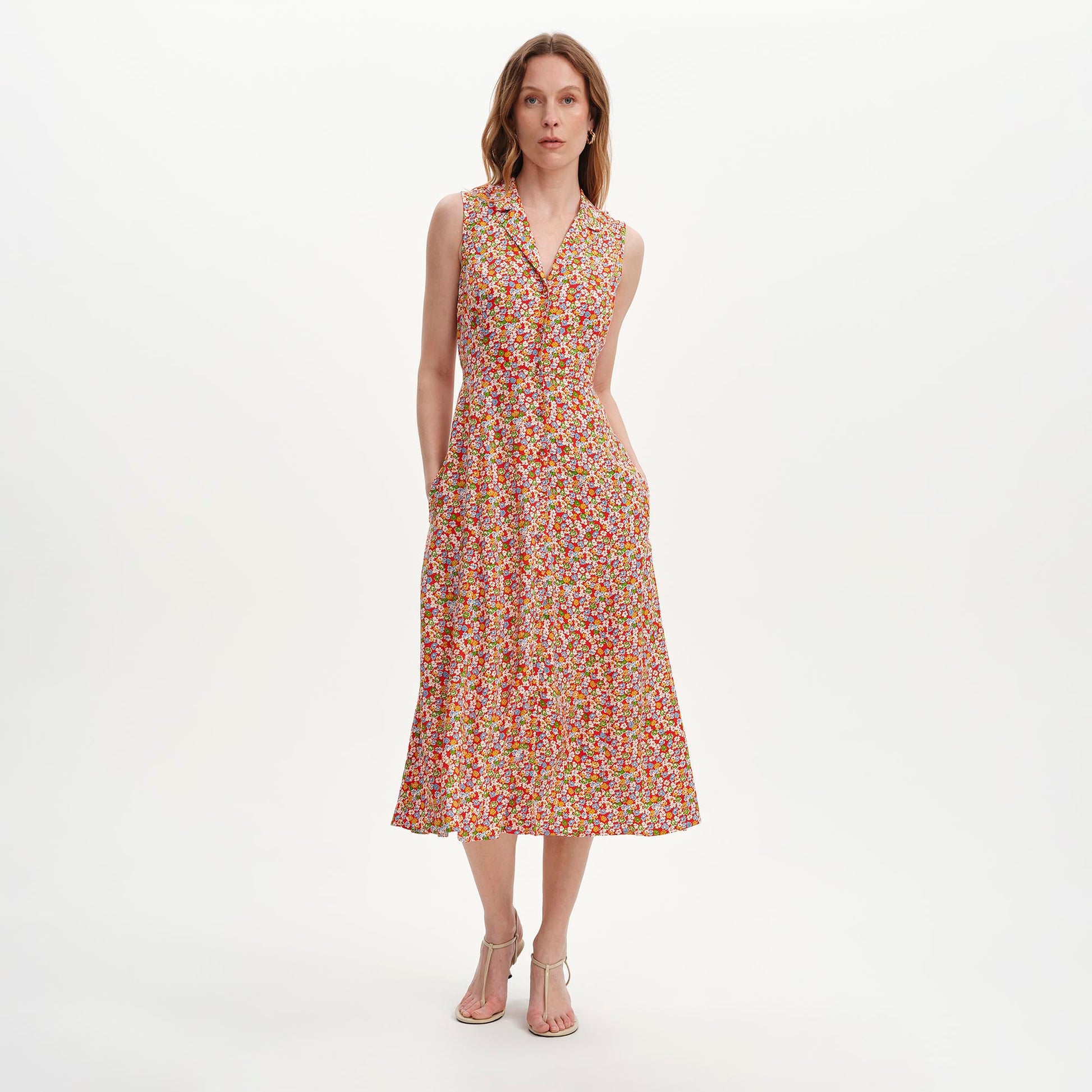 Woman wearing Beatrice Red Ditsy Sleeveless Midi Shirt Dress on a white background