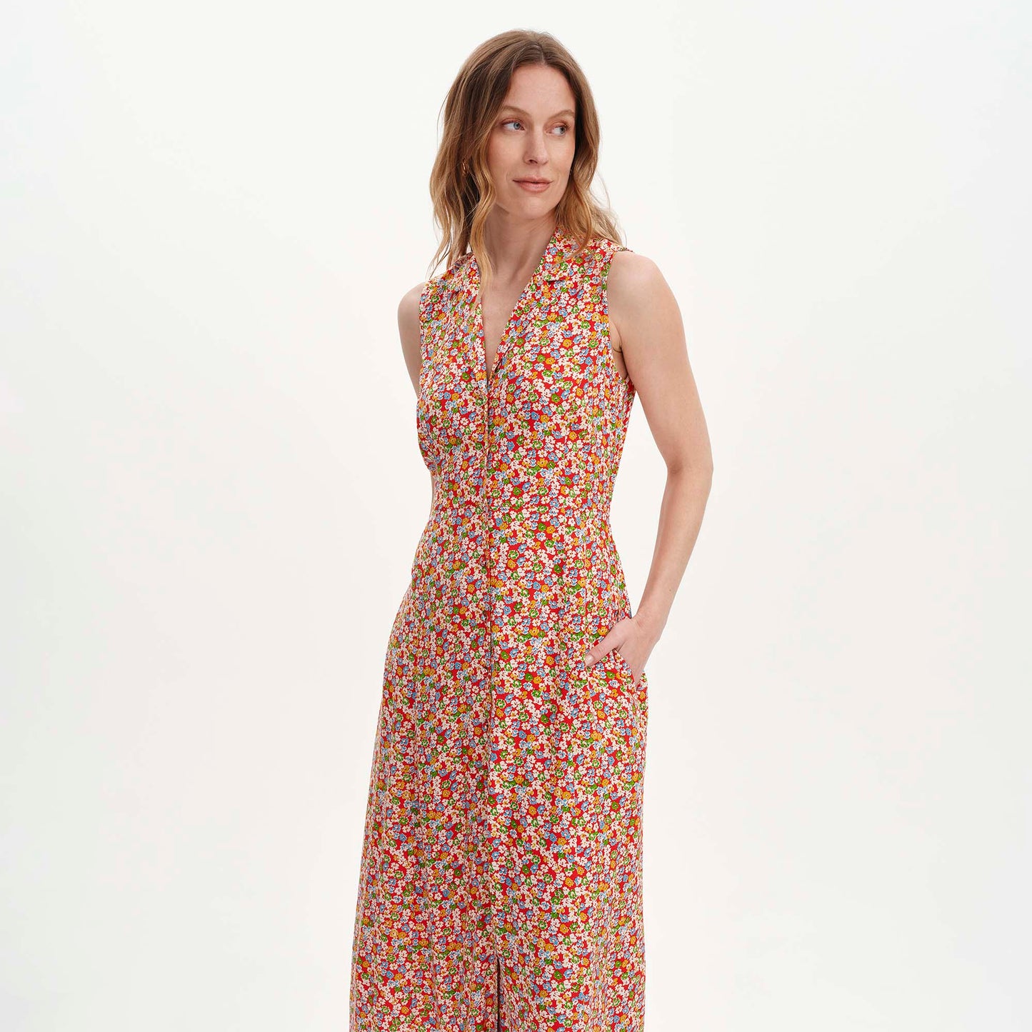 Woman wearing Beatrice Red Ditsy Sleeveless Midi Shirt Dress on a white background