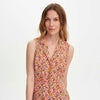 Woman wearing Beatrice Red Ditsy Sleeveless Midi Shirt Dress on a white background