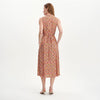 Woman wearing Beatrice Red Ditsy Sleeveless Midi Shirt Dress on a white background