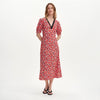 Woman wearing Elish Red Ditsy Lace Trim Puff Sleeve Midi Dress on a white background