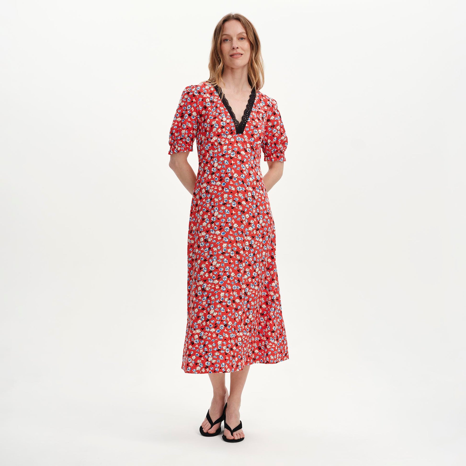 Woman wearing Elish Red Ditsy Lace Trim Puff Sleeve Midi Dress on a white background