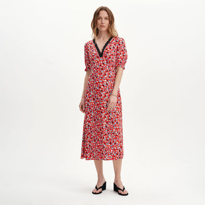Woman wearing Elish Red Ditsy Lace Trim Puff Sleeve Midi Dress on a white background