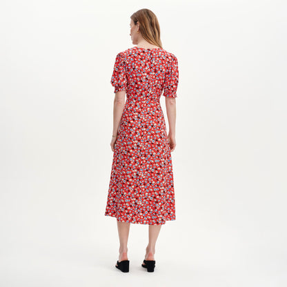 Woman wearing Elish Red Ditsy Lace Trim Puff Sleeve Midi Dress on a white background
