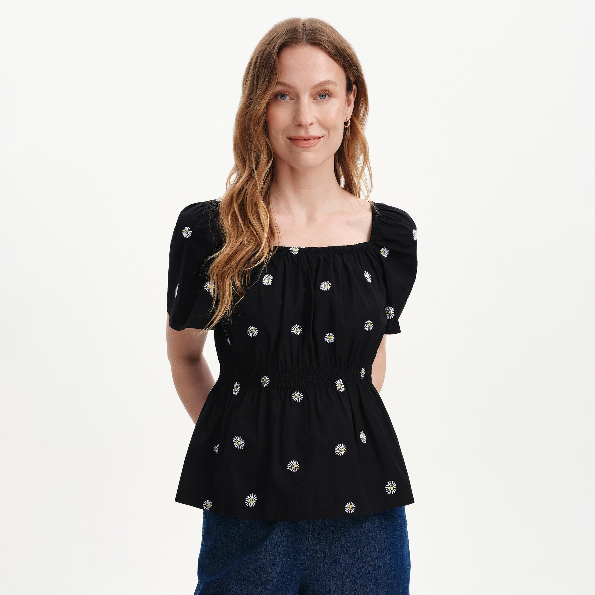 Woman wearing Holly Black Floral Embroidered Puff Sleeve Top on a white background