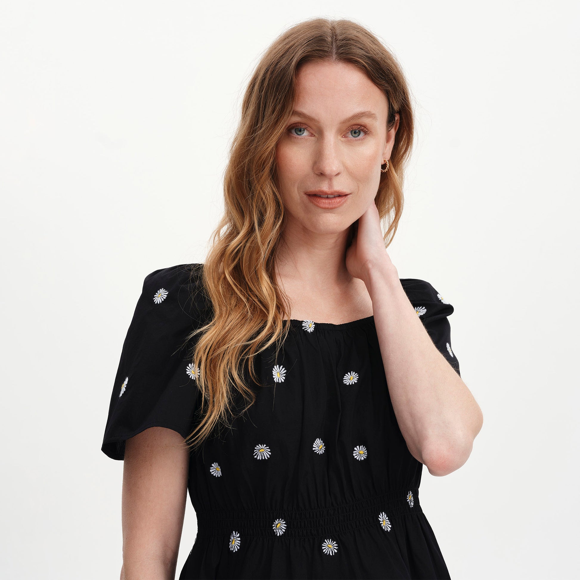 Woman wearing Holly Black Floral Embroidered Puff Sleeve Top on a plain background