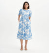 Woman wearing Jessa Blue Floral Puff Sleeve Midi Tiered Dress on a white background