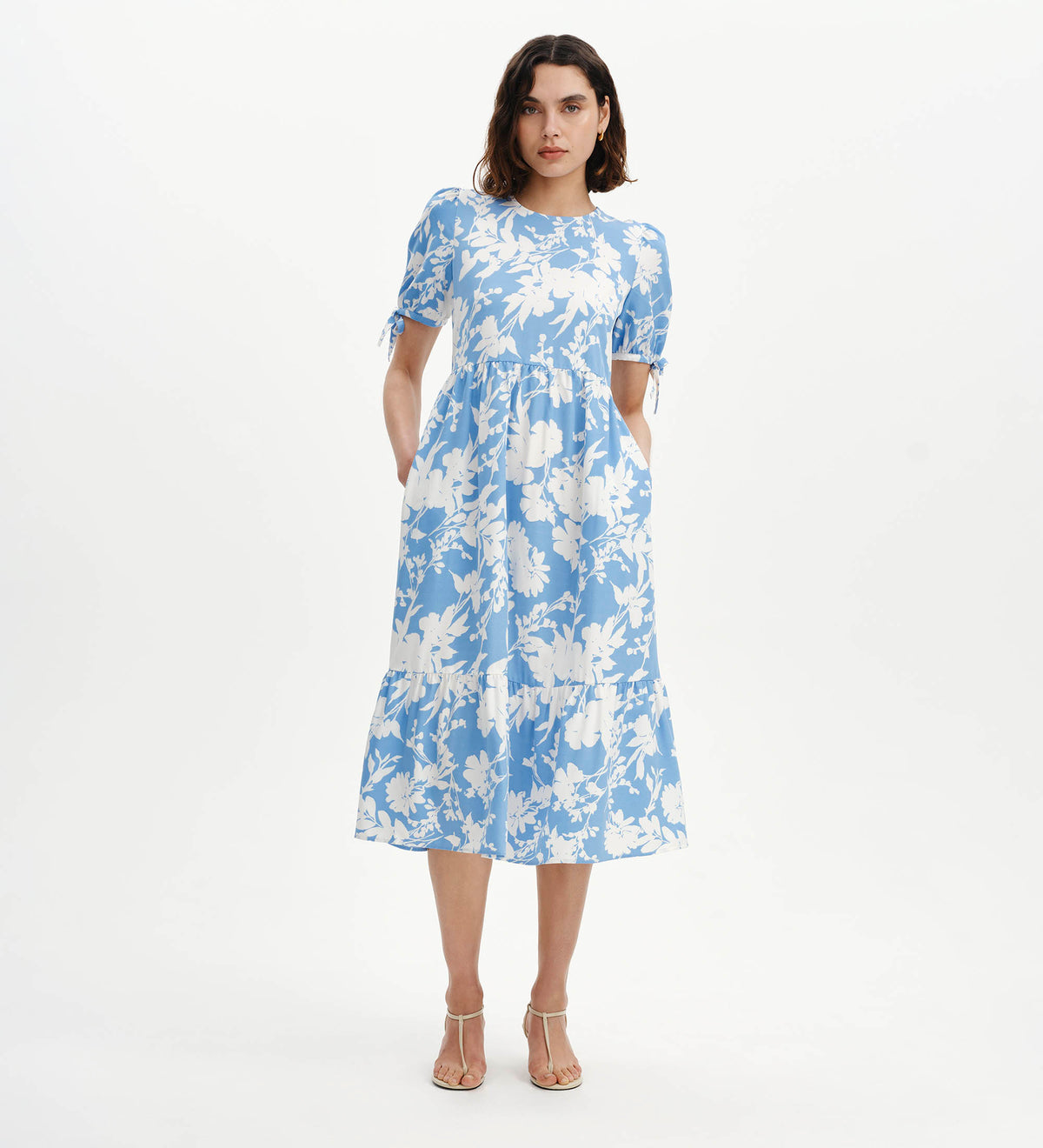 Woman wearing Jessa Blue Floral Puff Sleeve Midi Tiered Dress on a white background