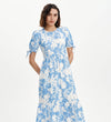 Woman wearing Jessa Blue Floral Puff Sleeve Midi Tiered Dress on a white background