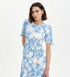 Woman wearing Jessa Blue Floral Puff Sleeve Midi Tiered Dress on a white background