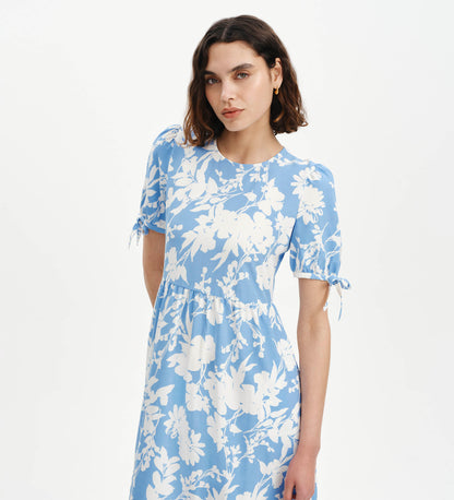 Woman wearing Jessa Blue Floral Puff Sleeve Midi Tiered Dress on a white background