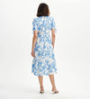 Woman wearing Jessa Blue Floral Puff Sleeve Midi Tiered Dress on a white background