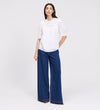 Woman wearing Jolin White Lace Cotton Puff Sleeve Top and blue jeans on a white background