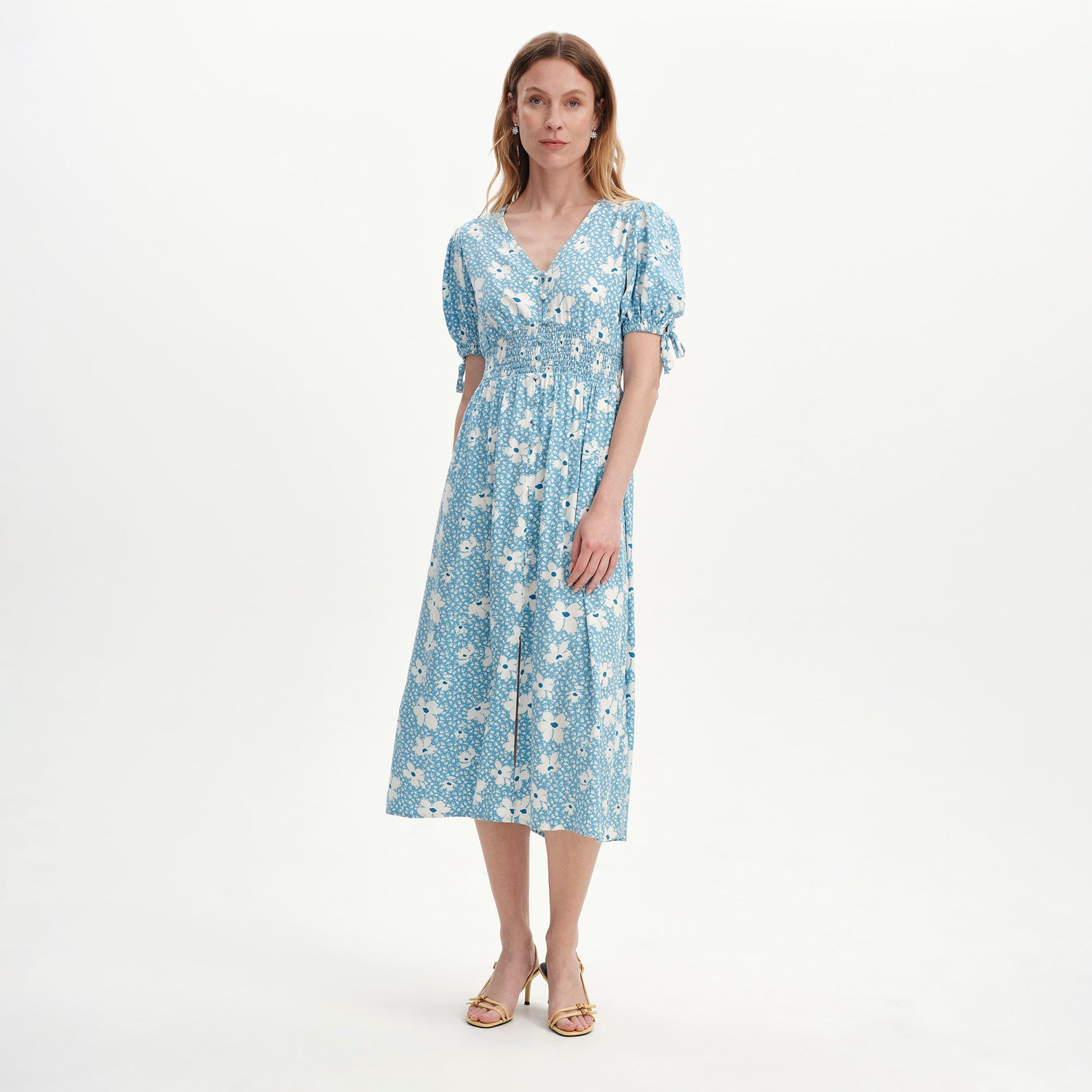 Woman wearing Margot Blue Ditsy Puff Sleeve Button Through Midi Dress on a white background