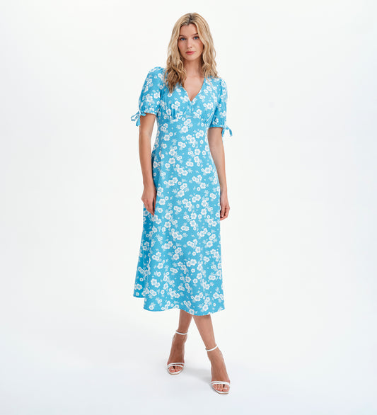 Woman wearing a blue floral dress on a white background