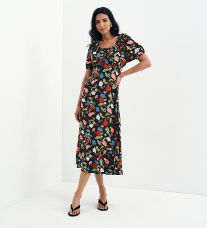 Woman wearing Jada Black Floral Puff Sleeve Empire Waist Midi Dress on a white background