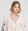 Woman wearing Karlee Neutral Stripe Embroidered Cotton Tie Front Blouse on a plain background