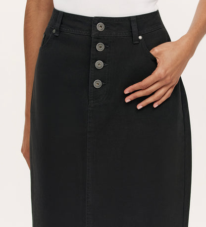 Close-up of a person wearing the Beth Black Canvas Midi Skirt, featuring a high waistband, four front buttons, a side pocket with one hand in it, paired with a white top.