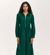A woman with long curly hair wears the Callie Bottle Green Corduroy Midi Dress, which features a collared neckline, long sleeves, front zipper, and gathered waist, standing against a plain light background.