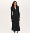 A woman wearing the Elvira Black Jersey Midi Dress, featuring a collared neckline, long sleeves, and a front zip, stands against a plain white background.