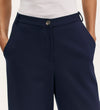 A person wears Marissa Navy Wide Leg Trousers in soft jersey, paired with a white top, hands in pockets, shown from waist to mid-thigh against a plain background.