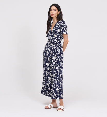 Woman wearing Uma Navy Floral Belted Wide Leg Jumpsuit on a white background