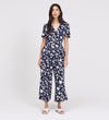 Woman wearing Uma Navy Floral Belted Wide Leg Jumpsuit on a white background