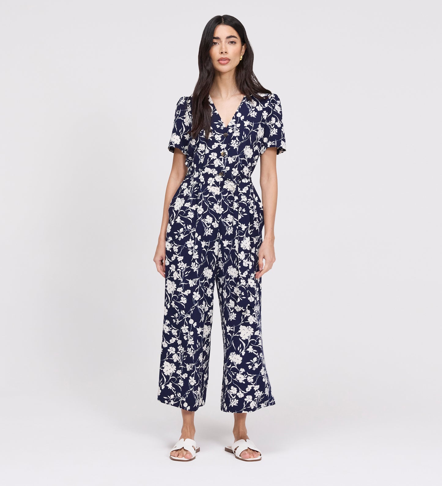 Woman wearing Uma Navy Floral Belted Wide Leg Jumpsuit on a white background
