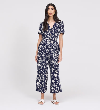 Woman wearing Uma Navy Floral Belted Wide Leg Jumpsuit on a white background