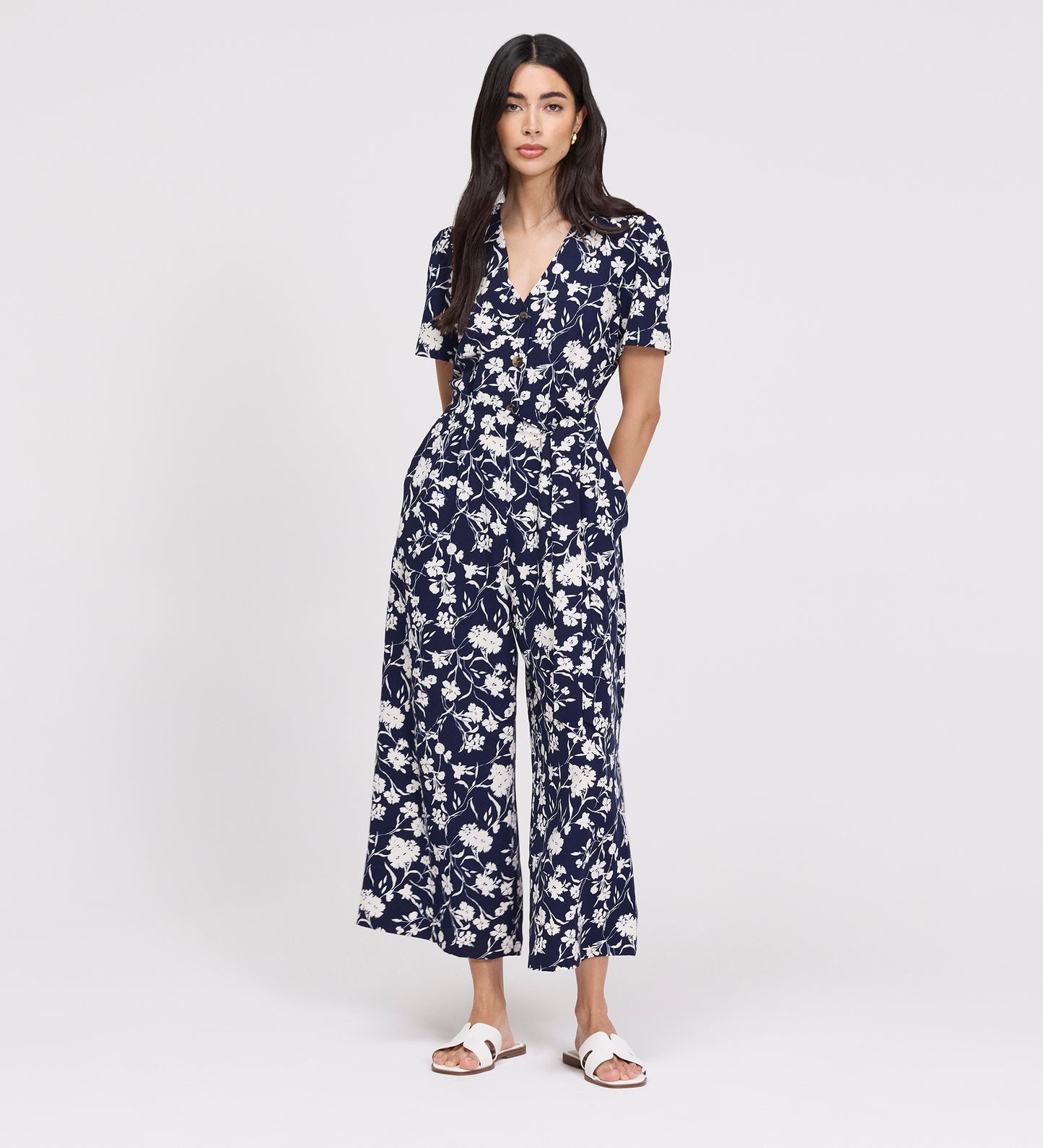 Woman wearing Uma Navy Floral Belted Wide Leg Jumpsuit on a white background