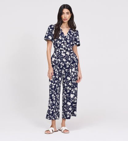 Woman wearing Uma Navy Floral Belted Wide Leg Jumpsuit on a white background
