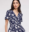 Woman wearing Uma Navy Floral Belted Wide Leg Jumpsuit against a plain background