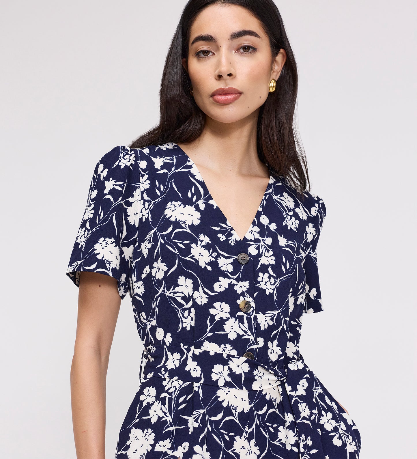 Woman wearing Uma Navy Floral Belted Wide Leg Jumpsuit against a plain background