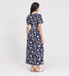 Woman wearing Uma Navy Floral Belted Wide Leg Jumpsuit on a white background