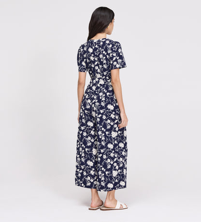 Woman wearing Uma Navy Floral Belted Wide Leg Jumpsuit on a white background